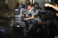 Israeli police officers clash with Palestinian protesters near Damascus Gate just outside Jerusalem's Old City, Sunday, May 9, 2021. (AP Photo/Ariel Schalit)