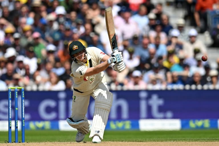 On the attack: Australia's Steve Smith hits out against England in the fourth Test at Old Trafford (Oli SCARFF)