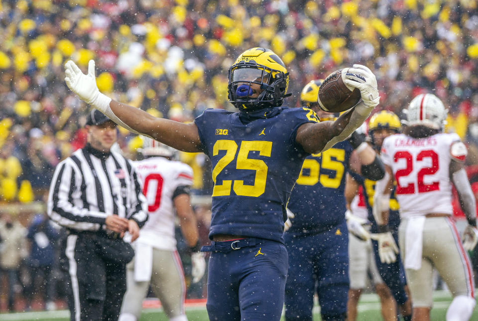 Michigan running back Hassan Haskins (25) celebrates a touchdown in the fourth quarter of an NCAA college football game against Ohio State in Ann Arbor, Mich., Saturday, Nov. 27, 2021. Michigan won 42-27. (AP Photo/Tony Ding)