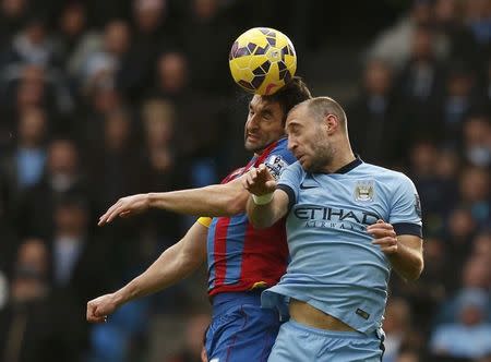 Manchester City's Pablo Zabaleta (R) challenges Crystal Palace's Mile Jedinak during their English Premier League soccer match at the Etihad Stadium in Manchester, northern England December 20, 2014. REUTERS/Phil Noble