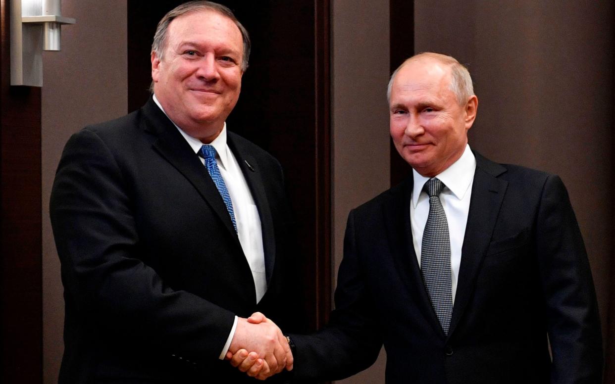 Mike Pompeo and Vladimir Putin shake hands during meeting in Sochi - AFP