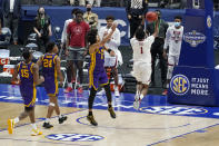 Alabama's Herbert Jones (1) scores the go-ahead layup in the final seconds to give Alabama the win over LSU in the championship game at the NCAA college basketball Southeastern Conference Tournament Sunday, March 14, 2021, in Nashville, Tenn. Alabama won 80-79. (AP Photo/Mark Humphrey)