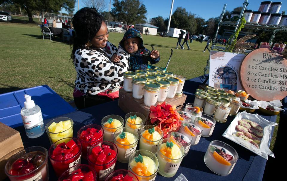 Rose Barnes and her son Malcolm, 2, display decorative candles at Monday's festival.