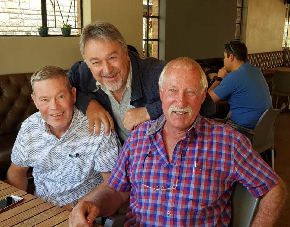 This undated photo shows South African photographer John Parkin, left, with fellow photographer Meter Morey in Pretoria, South Africa. Parkin, who covered the country's anti-apartheid struggle, its first democratic elections, and the presidency of Nelson Mandela, has died Monday Aug. 23, 2021, at the age of 63 .