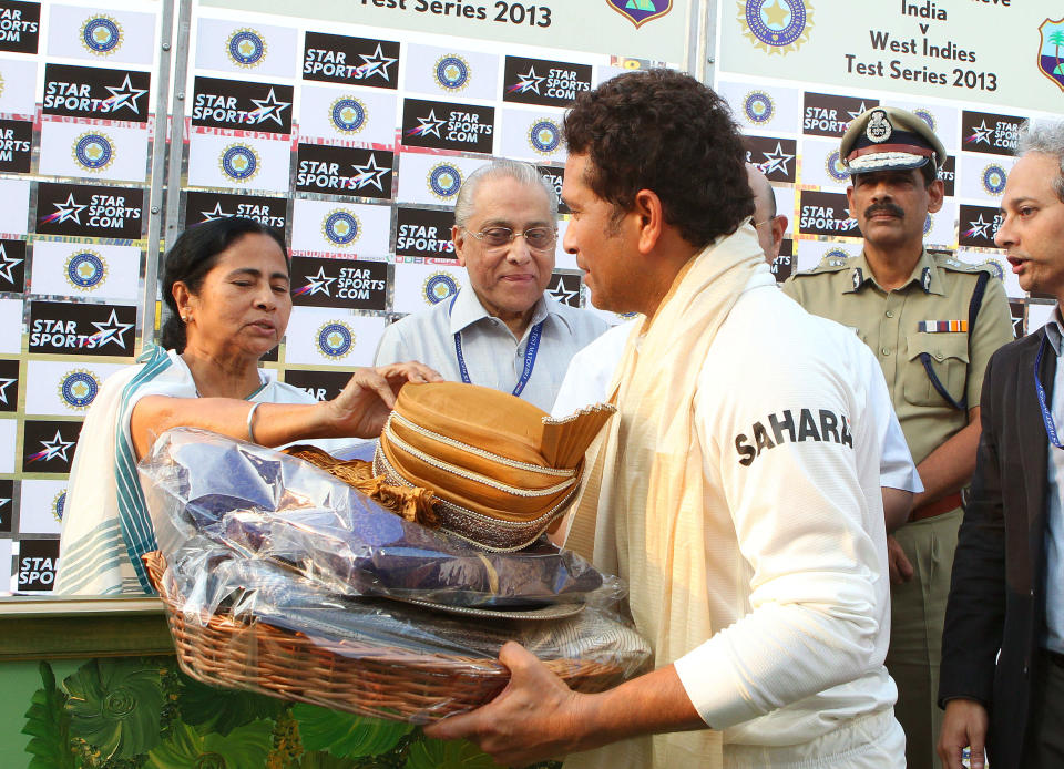 Mamata Banerjee (Chief Minister of West Bengal) presents Sachin Tendulkar with a memento during day three of the first Star Sports test match between India and The West Indies held at The Eden Gardens Stadium in Kolkata, India on the 8th November 2013. (BCCI Photo)