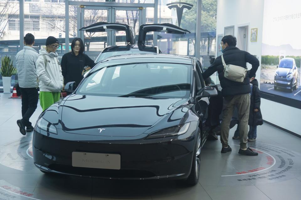 HANGZHOU, CHINA - JANUARY 07 2024: People visit a Tesla dealership in Hangzhou in east China's Zhejiang province. Tesla will recall over 1.6 million cars in China to correct an autopilot defect. (Photo credit should read LONG WEI / Feature China/Future Publishing via Getty Images)