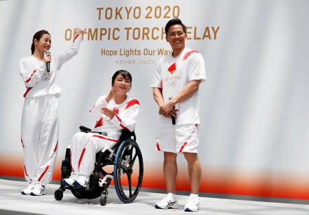 Tokyo 2020 Torch Relay Official Ambassadors, actress Satomi Ishihara, paralympian Aki Taguchi and judoist Tadahiro Nomura unveil the Olympic torchbeares' uniform during a Torch Relay event in Tokyo