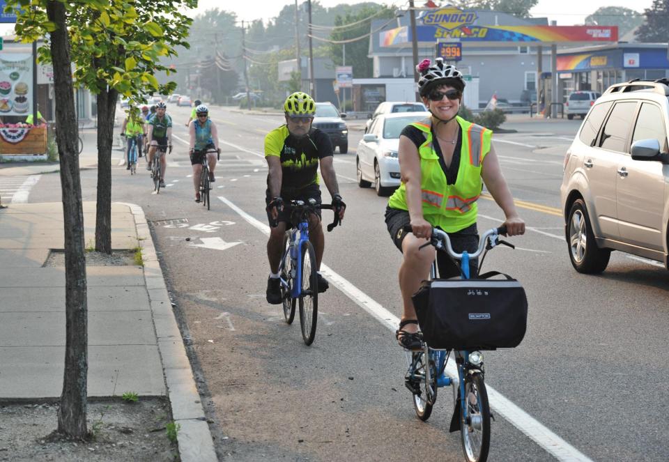 Quincyles founder Irene Lutts, of Quincy, leads a group of bicyclists along Adams Street in Quincy on Monday, July 26, 2021.