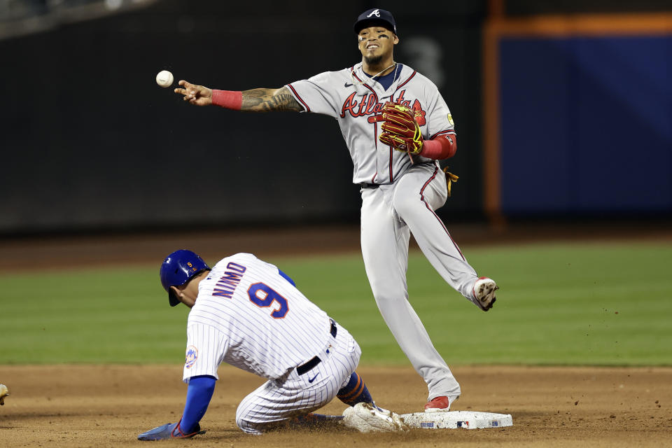 Atlanta Braves shortstop Orlando Arcia, top, gets an out against New York Mets' Brandon Nimmo (9) but fails to turn a double play during the fifth inning of a baseball game Sunday, Aug. 13, 2023, in New York. (AP Photo/Adam Hunger)