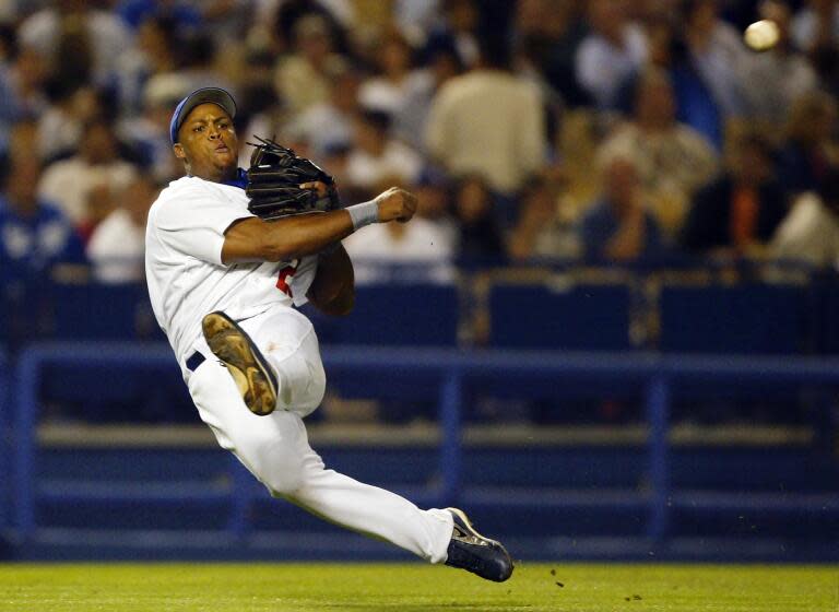 Dodgers third baseman Adrian Beltre throws out Brewers' Gary Bennett during a baseball game.