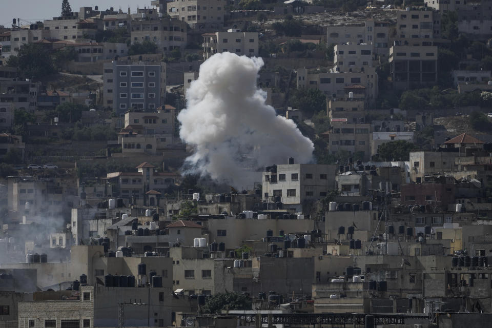 Smoke rises during an Israeli military raid of the militant stronghold of Jenin in the occupied West Bank, Monday, July 3, 2023. Palestinian health officials say at least three Palestinians were killed in the raid. (AP Photo/Majdi Mohammed)