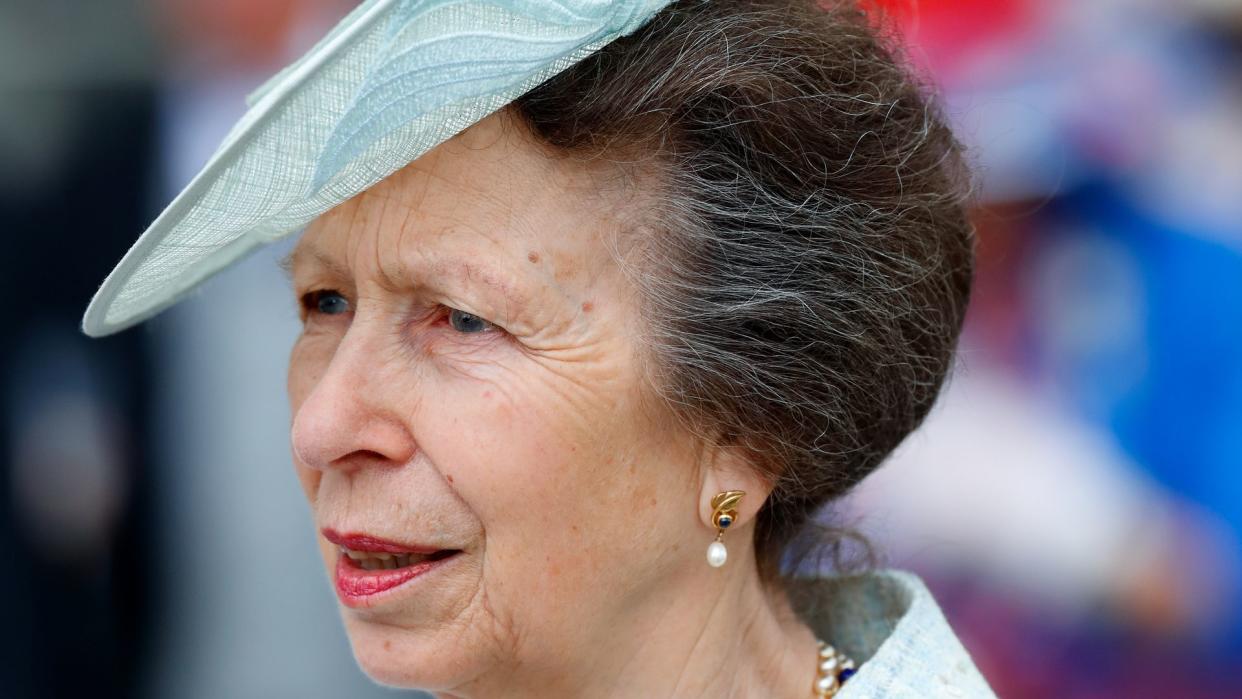 Princess Anne in blue outfit and fascinator