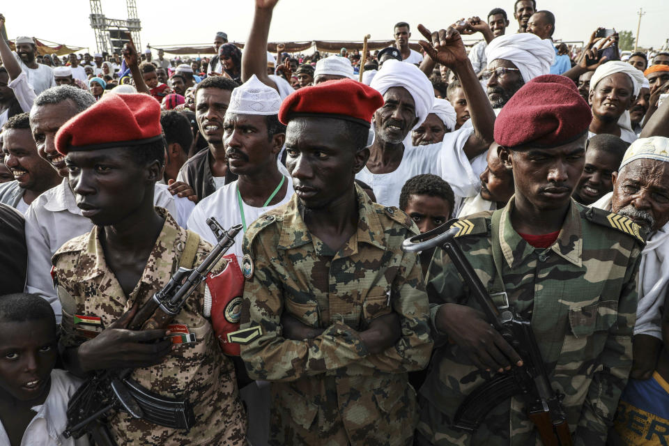 Members of the military stand as Gen. Mohammed Hamdan Dagalo, the deputy head of the military council, speaks during a military-backed tribe's rally, in the Nile River State, Sudan, Saturday, , on July 13, 2019. . (AP Photo/Mahmoud Hjaj)