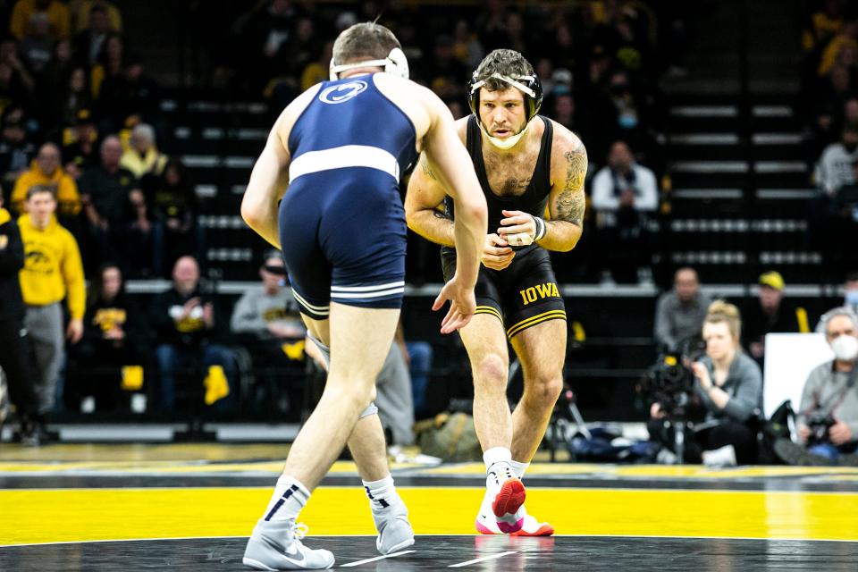 Penn State's Nick Lee, left, wrestles Iowa's Jaydin Eierman at 141 pounds on Jan. 28 at Carver-Hawkeye Arena in Iowa City.