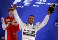 Mercedes driver Lewis Hamilton celebrates on the podium after winning the Bahrain Grand Prix on April 19, 2015