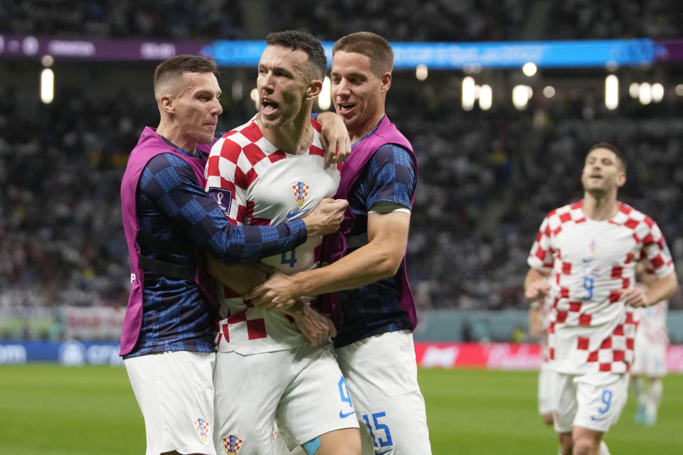 Croatia's Ivan Perisic, second left, celebrates with teammates after scoring his side's opening goal during the World Cup round of 16 soccer match between Japan and Croatia at the Al Janoub Stadium in Al Wakrah, Qatar, Monday, Dec. 5, 2022. (AP Photo/Thanassis Stavrakis)