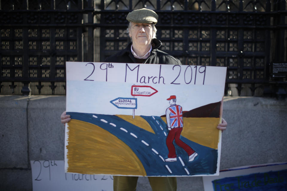 A leave the European Union supporter who didn't want to give his name poses for photographs outside the Houses of Parliament in London, Thursday, Feb. 14, 2019. This demonstrator believes leaving the European Union for Britain to make its own laws would the best way forward. Some demonstrators have been coming to the grounds outside parliament for days, weeks or even months, to make their case as to whether Britain should stay inside the European Union or leave on March 29, as planned. (AP Photo/Matt Dunham)