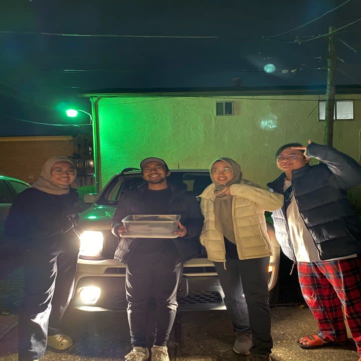 Left: Akmal Razak (second from left) and his friends on the drive from Columbus to NYC. Right: Razak handing the ballots to Choi.