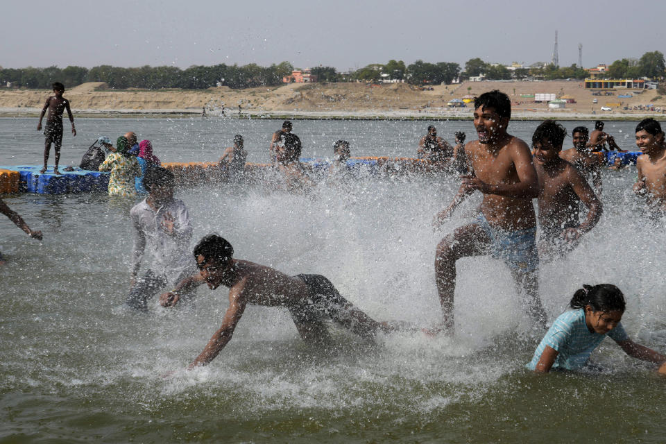 People play in the river Ganges to cool themselves from the heat in Prayagraj, Uttar Pradesh state, India, Monday, June 17, 2024. A monthslong heatwave across swathes of India has killed more than 100 people and led to over 40,000 suspected cases of heat stroke in the last three and a half months, a Health Ministry official said Thursday, June 20. (AP Photo/Rajesh Kumar Singh)