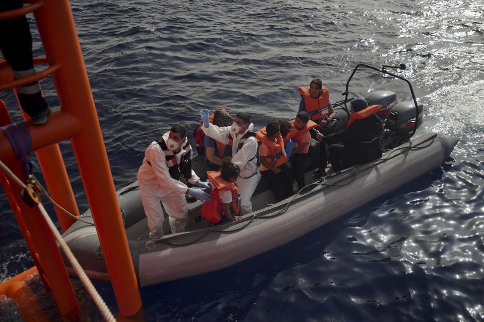 Members of the Maltese Armed Forces help migrant children disembark from the Ocean Viking and board their rescue boat in the Mediterranean Sea, Friday, Sept. 20, 2019. Malta has agreed to take in 35 migrants fleeing Libya who were rescued by the humanitarian ship a day earlier. (AP Photo/Renata Brito)