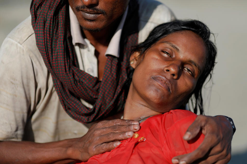 Arif Ullah, who said his village was burned down and his relatives were killed by Myanmar soldiers, comforts his wife Shakira who collapsed from exhaustion as Rohingya refugees arrive by a wooden boat from Myanmar to the shore of Shah Porir Dwip, in Teknaf, near Cox's Bazar in Bangladesh, on Oct. 1. Reuters photographer Damir Sagolj: "That morning, a group of Rohingya refugees crossed the Bay of Bengal on a rickety, wooden boat, for landings at Shah Porir Dwip, a village at the mouth of the Naf River. Most of the refugees, exhausted from the trip, collapsed after finally reaching the shores of Bangladesh. Shakira, unable to stand on her own, rested in her husband's arms for some 10 to 15 minutes before getting up and continuing on foot towards a relief center nearby."