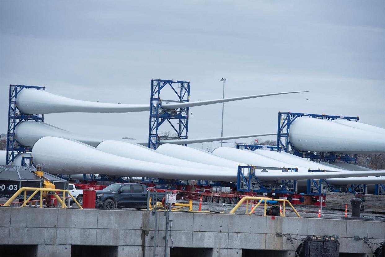 Wind turbine blades sit on a barge on March 2 at the Vineyard Wind 1 construction staging facility at the New Bedford Marine Commerce Terminal. A sister project to Vineyard Wind 1 is among the four submissions made on Wednesday in a multi-state bid solicitation for more offshore wind power.