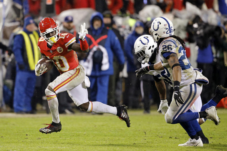 FILE - In this Jan. 12, 2019, file photo, Kansas City Chiefs wide receiver Tyreek Hill (10) gives Indianapolis Colts linebacker Anthony Walker (50) and safety Clayton Geathers (26) the peace sign as he rushes for a first down during an NFL AFC Divisional football game at Arrowhead Stadium in Kansas City, Mo. The Kansas City Chiefs have made a habit of inciting controversy during the NFL draft in the Andy Reid era by acquiring players that have a history of off-the-field issues. The team took a chance on cornerback Marcus Peters, who was traded away after getting into trouble with coaches. It drafted running back Kareem Hunt, then quickly cut him when he kicked a woman in a hotel hallway. And it picked wide receiver Tyreek Hill, who is currently dealing with a domestic violence case that centers on the 3-year-old child he shares with his fiance. (AP Photo/Colin E. Braley, File)