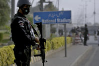 Police commando stands guard on the arrival of South Africa's cricket team for a practice session at the National Cricket Stadium, in Karachi, Pakistan, Saturday, Jan. 23, 2021. South Africa, which arrived in the southern port city of Karachi for the first time in nearly 14 years, will play the first test match against Pakistan starting on Jan. 26. (AP Photo/Fareed Khan)