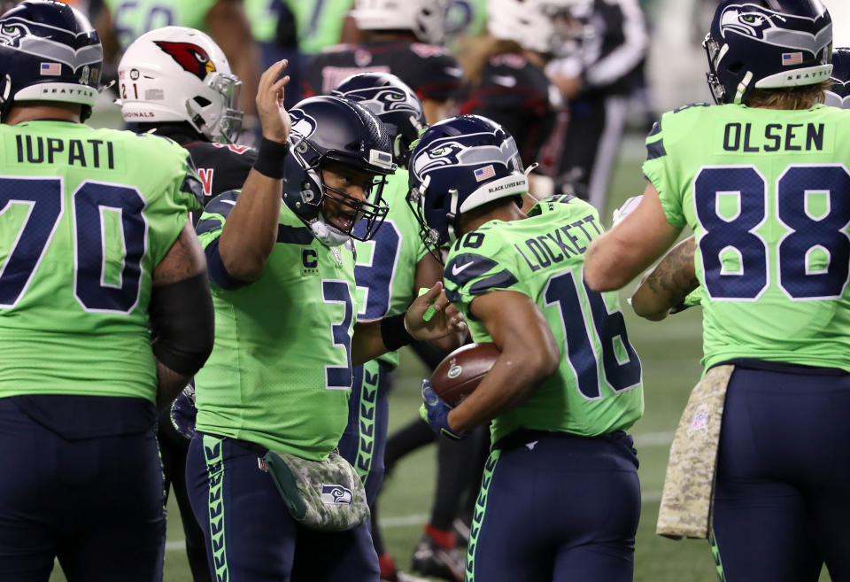 Russell Wilson congratulates Tyler Lockett after his touchdown catch against the Cardinals. (Photo by Abbie Parr/Getty Images)