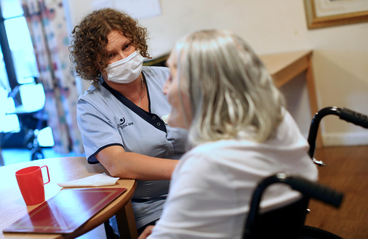 A care worker talks to a resident at a nursing home in south London, as research has revealed that care home residents were more likely to die of Covid-19 in the UK than in any of the major European countries apart from Spain. Picture date: Wednesday July 1, 2020. 