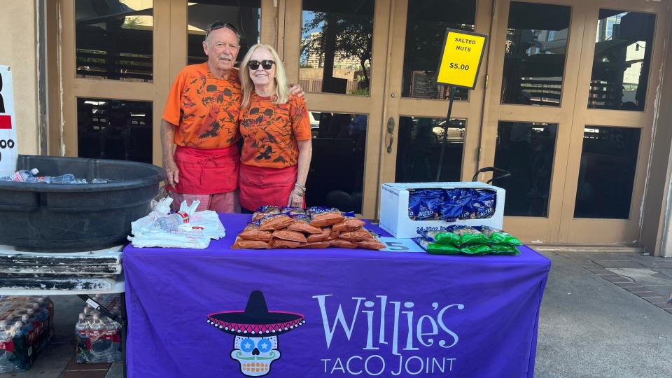 "Big Ray" and Carol White sell water and peanuts outside of Chase Field before Game 4 of the World Series between the Arizona Diamondbacks and Texas Rangers in Phoenix on Oct. 31 2023.