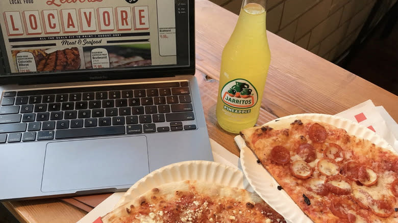 Basil Doc's pizza next to laptop