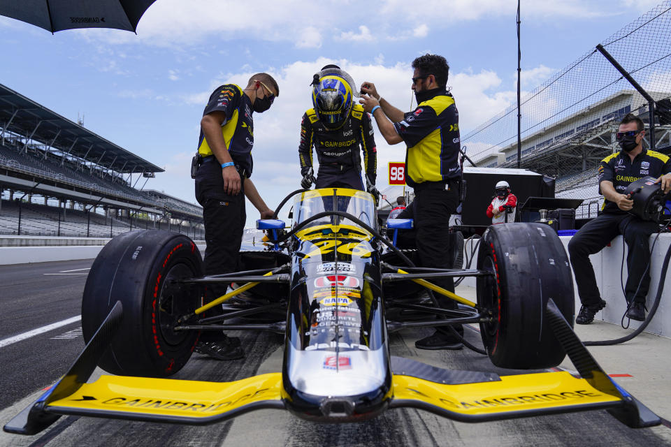 Zach Veach climbs into his car during practice for the Indianapolis 500 auto race at Indianapolis Motor Speedway in Indianapolis, Friday, Aug. 14, 2020. (AP Photo/Michael Conroy)