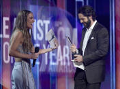 Ingrid Andress, left, presents the award for male artist of the year to Thomas Rhett at the 56th annual Academy of Country Music Awards on Sunday, April 18, 2021, at the Grand Ole Opry in Nashville, Te nn. (AP Photo/Mark Humphrey)