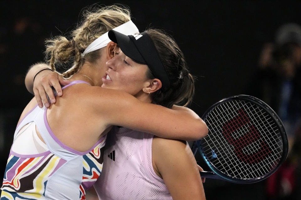 Jessica Pegula, right, of the U.S. embraces Victoria Azarenka of Belarus following their quarterfinal match at the Australian Open tennis championship in Melbourne, Australia, Tuesday, Jan. 24, 2023. (AP Photo/Aaron Favila)