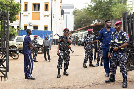 Police officers stand outside the high court in Freetown, Sierra Leone March 26, 2018. REUTERS/Olivia Acland