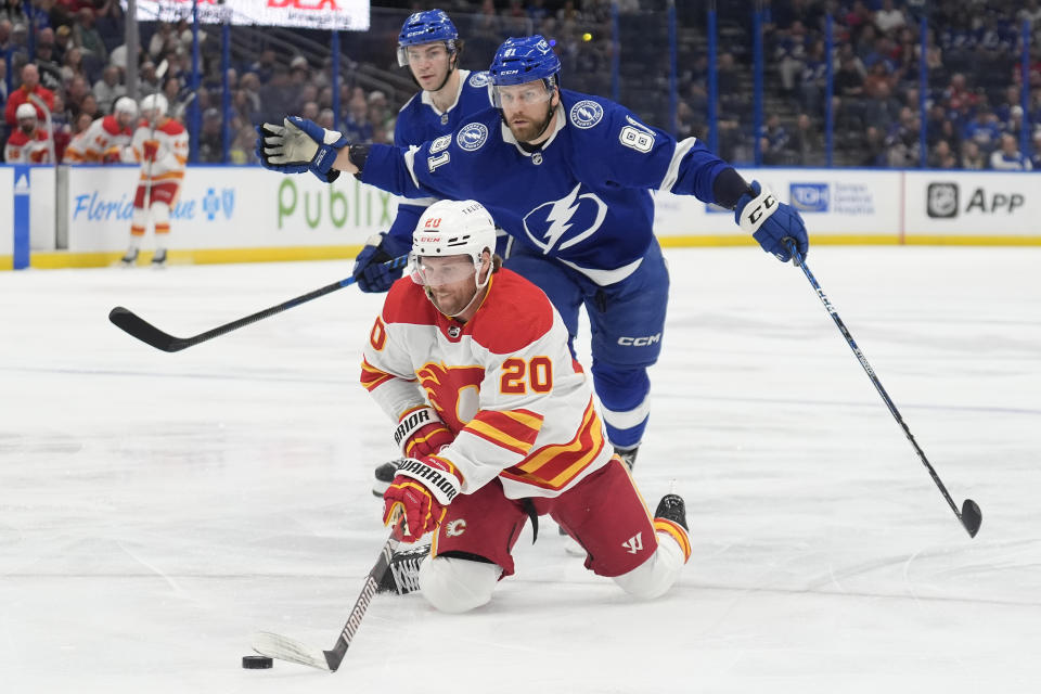 Tampa Bay Lightning defenseman Erik Cernak (81) reacts after taking down Calgary Flames center Blake Coleman (20) during the first period of an NHL hockey game Thursday, March 7, 2024, in Tampa, Fla. Cernak was penalized on the play. (AP Photo/Chris O'Meara)