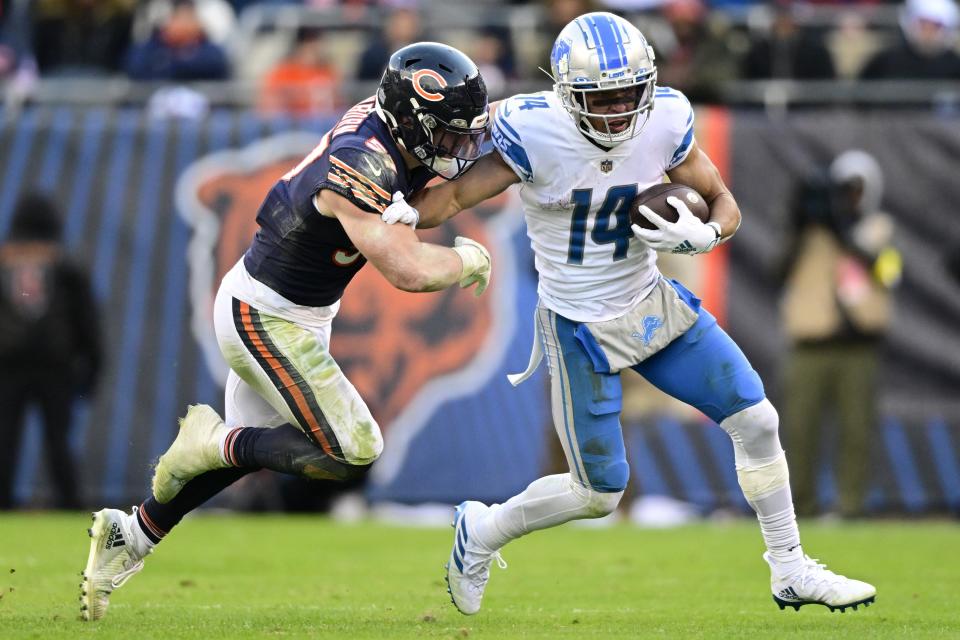 Lions wide receiver Amon-Ra St. Brown runs for a first down against the Bears' Jack Sanborn during the Lions' 31-30 win on Sunday, Nov. 13, 2022, in Chicago.