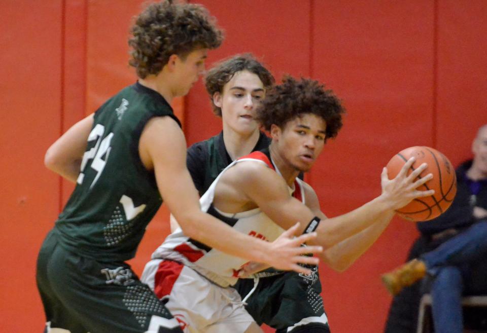 Barnstable's Ka'ron Ford looks to get around D-Y's Trey McPherson, left, and Connor Bosiak in first quarter action.