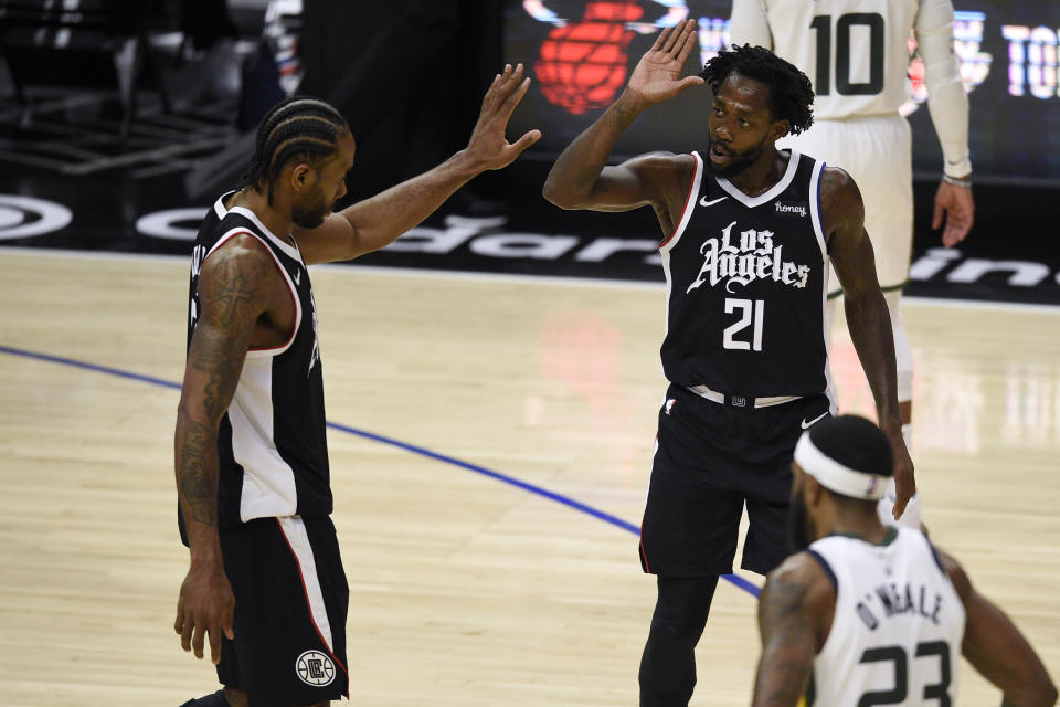 Los Angeles Clippers guard Patrick Beverley, right, celebrates with forward Kawhi Leonard during the second half of the team's NBA basketball game against the Utah Jazz in Los Angeles, Friday, Feb. 19, 2021. (AP Photo/Kelvin Kuo)