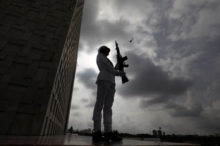 A cadet of the Pakistan Navy, positions during a ceremony to celebrate Pakistan's 72nd Independence Day in Karachi