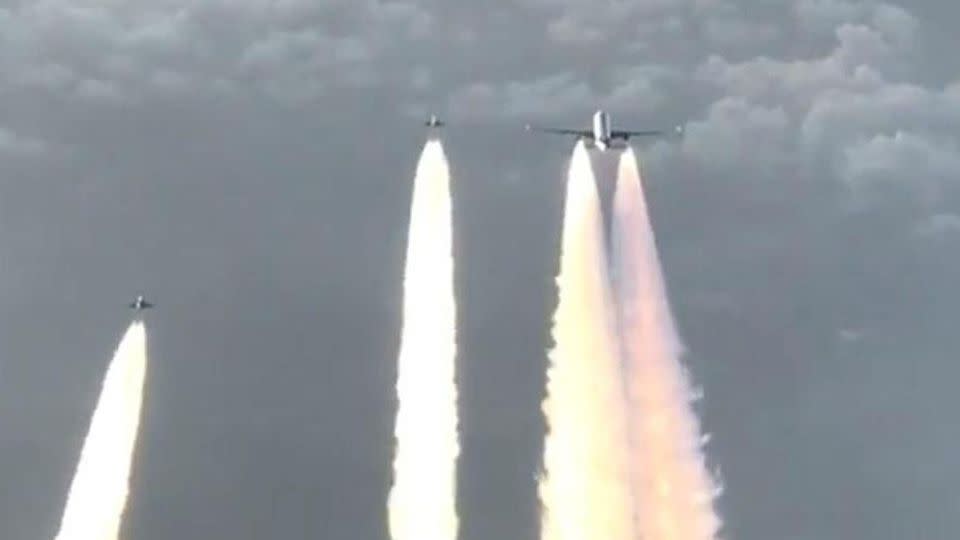 The nail-biting moment the two jets come to the assistance of the passenger plane. Source: Facebook