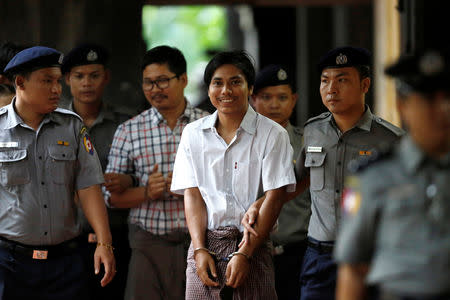 FILE PHOTO: Police escort detained Reuters journalists Kyaw Soe Oo and Wa Lone as they arrive before a court hearing in Yangon, Myanmar, August 20, 2018. REUTERS/Ann Wang