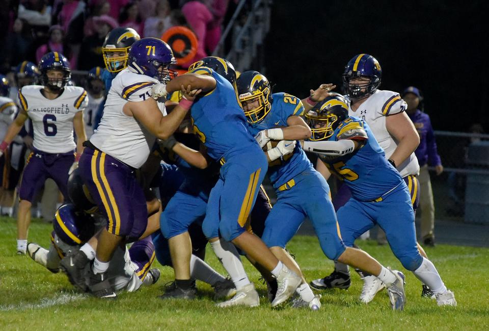 Gavin Albing of Ida looks for a hole in the middle of the line as Julius Brown and teammates of Blissfield make the stop at the line of scrimmage Friday, October 6, 2023.