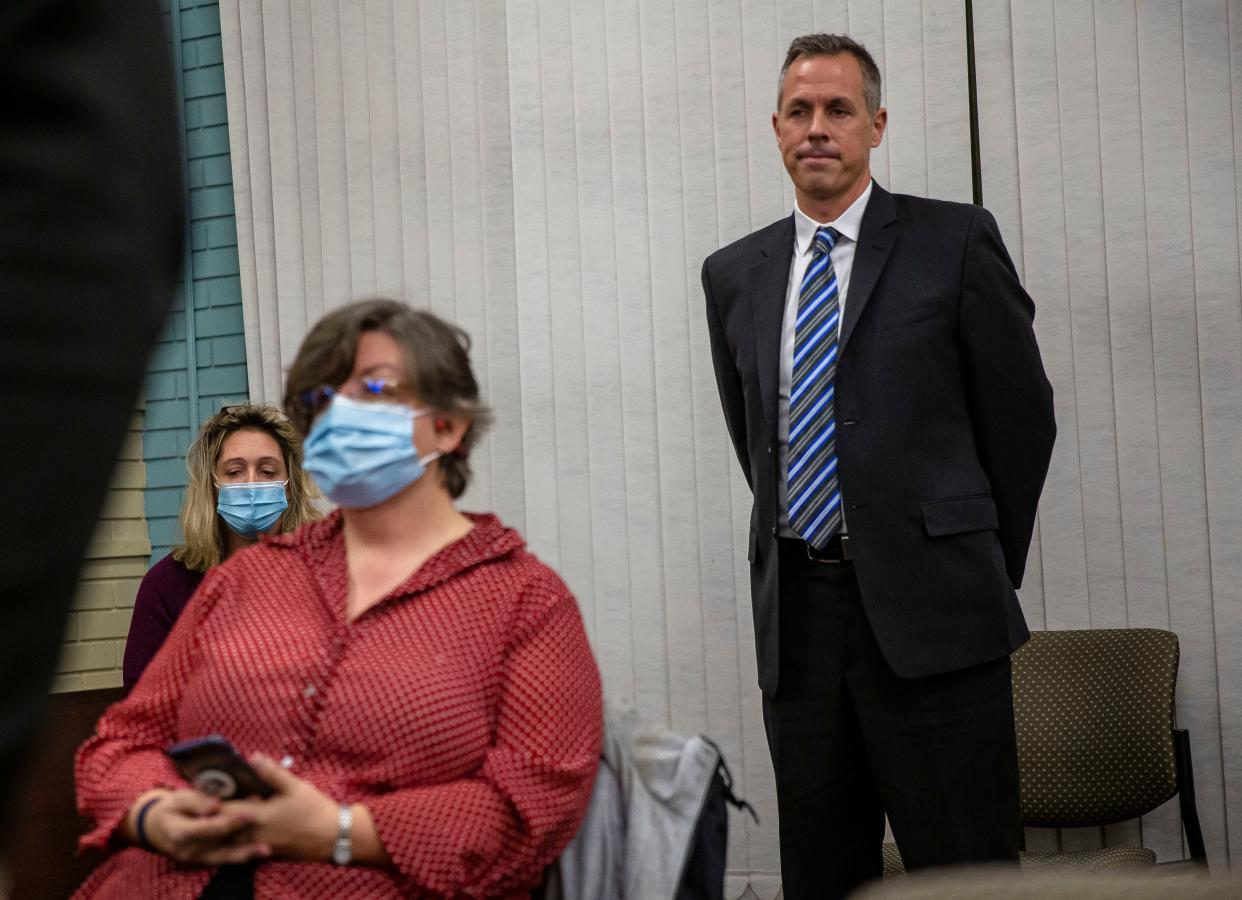 Kingsley Keys, a music teacher at Franklin Middle School, stands up as the Springfield School District 186 board of education votes to dismiss him after he defied a state mandate requiring teachers to provide proof of COVID-19 vaccinations or submit to weekly testing during a board meeting at the District 186 headquarters in Springfield on Monday, Nov. 15, 2021.