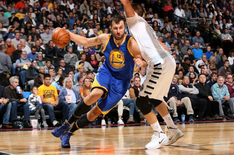 Andrew Bogut of the Golden State Warriors drives with the ball against Nikola Jokic of the Denver Nuggets on November 22, 2015 in Denver, Colorado