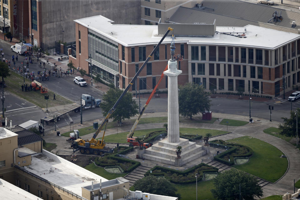 FILE - Workers prepare to take down the statue of former confederate general Robert E. Lee, which stands over 100 feet tall, in Lee Circle in New Orleans, Friday, May 19, 2017. A New Orleans city council member is pushing to change a street currently named after Confederate Gen. Robert E. Lee and replace it with one the city’s most famous musicians, Allen Toussaint. (AP Photo/Gerald Herbert, File)