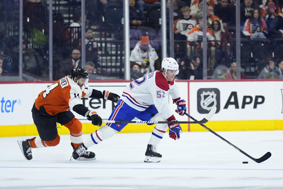 Montreal Canadiens' Justin Barron, right, tries to get away from Philadelphia Flyers' Sean Couturier during the third period of an NHL hockey game, Wednesday, Jan. 10, 2024, in Philadelphia. (AP Photo/Matt Slocum)