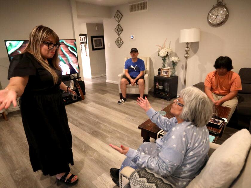 Mariella Rojas, left, opens her arms after her mother Rosa Angelica Saldana, asked for a hug.