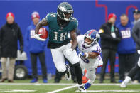 Philadelphia Eagles' Jalen Reagor, left, evades New York Giants' Collin Johnson during the first half of an NFL football game, Sunday, Nov. 28, 2021, in East Rutherford, N.J. (AP Photo/John Munson)